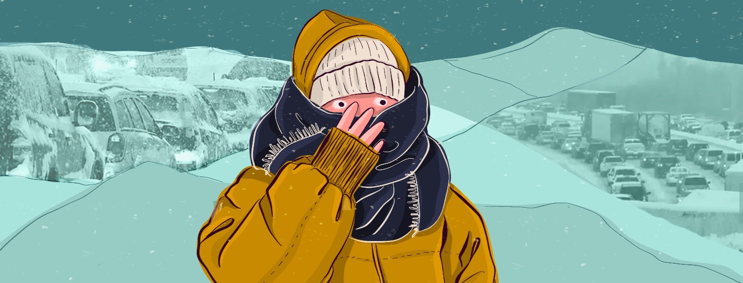 A person bundled up in winter weather gear clutches their scarf, revealing only their wide eyes.