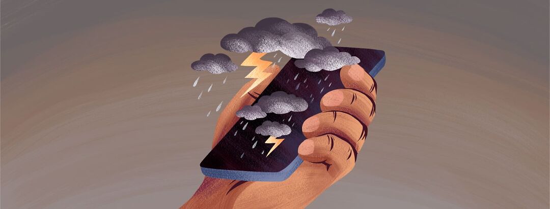 A person's hand holds a phone with storm clouds, thunder and rain over the screen